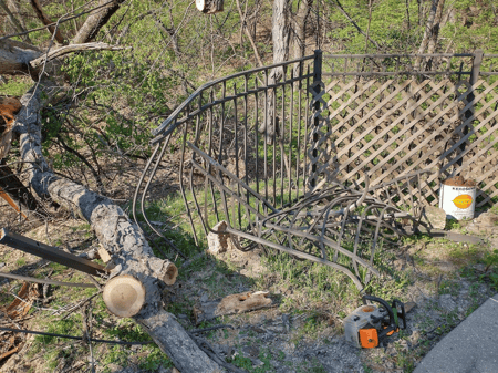 a damaged fence caused by a downed tree